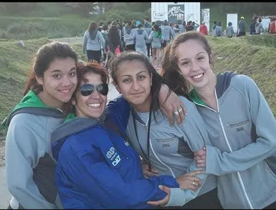 La Profe abrazada con tres alumnas